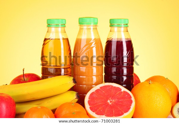 Download Bottles Juice Ripe Fruits On Yellow Stock Photo Edit Now 71003281 Yellowimages Mockups