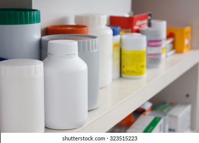 Bottles Of Medicine Pills Arranged On Shelf At Drugstore