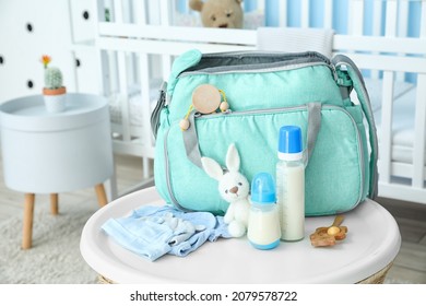 Bottles Of Milk For Baby And Bag On Table In Room