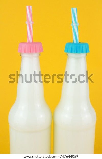 Download Bottles Milk On Yellow Colored Background Stock Photo Edit Now 747644059 PSD Mockup Templates