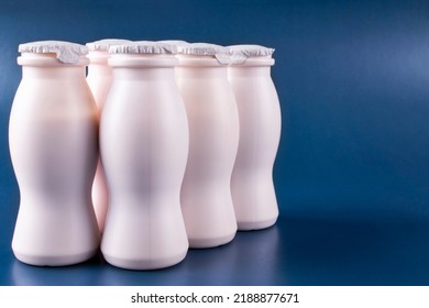 Bottles Of Milk Yogurt (kefir) On A Blue Background. Space For Text. The Concept Of Probiotics (bifidobacteria) And Healthy Nutrition. Packaging Of Fermented Milk Products.