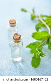 Bottles Of Mint Essential Oil On Table