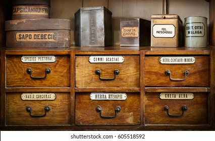 Bottles On The Shelf In Old Pharmacy. The Labels On Bottles And A Shelf  Inscription In Latin Language. Translation: Gum Arabic, Chalk White, Turmeric Root, Thoracic Collecting, Soap, Mustard, Cocoa