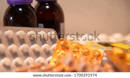 Bottles and pills. A tablet is the solid form of a medicated powder, prepared by compression, with or without added binders. Slots may be provided to allow dose sharing