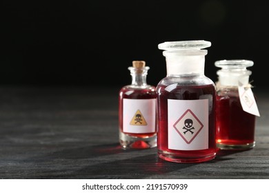 Bottles With Poison On Black Wooden Table. Space For Text