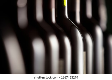 Bottles of red wine in a row on display in a restaurant