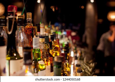 Bottles of spirits and liquor at the bar - Shutterstock ID 1244050168
