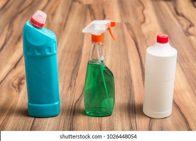 Bottles and spray products for household cleaning on the wooden floor. Cleaning concept. - Shutterstock ID 1026448054