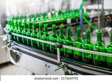 Bottling and conveyor line or belt at winery factory, Wine bottles filling production.