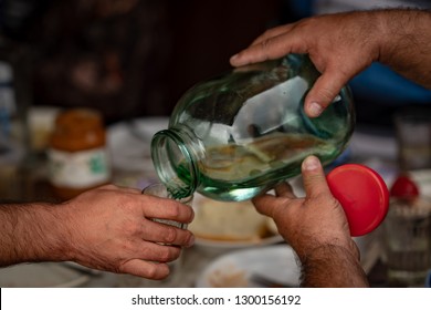 Bottling Of Moonshine From A Large Jar