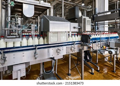 Bottling of pasteurized milk by equipment of production line - Shutterstock ID 2151383473
