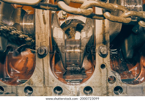Bottom of Crankshaft and Cylinder Block\
and Bolt of Car Engine and Chain in Vintage\
Tone