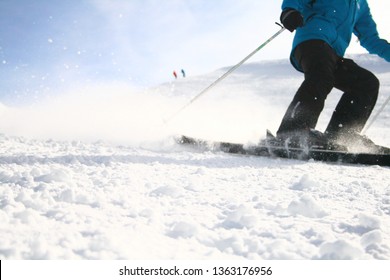 Bottom Half Of Skiier Coming Down Mountain Spraying Snow