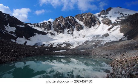 Bottom Of A Mountain With A Glassy Lake