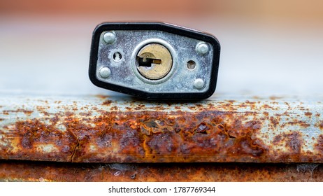 Bottom of Padlock laying on rusted metal surface - Shutterstock ID 1787769344