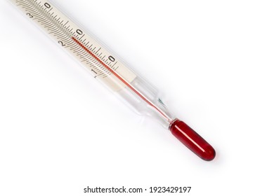 Bottom part of laboratory alcohol glass thermometer with Celsius units scale on a white background close-up, bulb of ethanol with red dye on a foreground 
