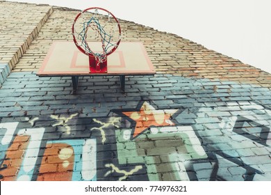 Bottom View Of Basketball Hoop On Wall With Colorful Graffiti 