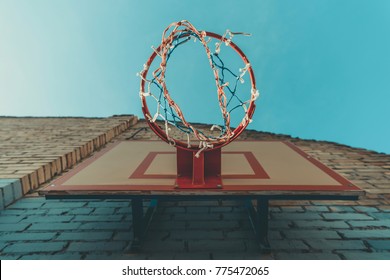 Bottom View Of Basketball Hoop On Wall With Graffiti 