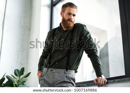 bottom view of bearded businessman standing and looking at camera Stock photo © 