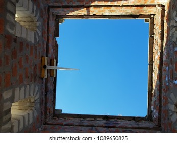 Bottom view of blue sky and clouds through the roof of abandoned building