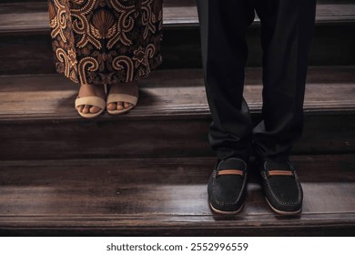 Bottom view of the boss and his colleagues. They stand on the stairs. Concept of position in work. Office work. - Powered by Shutterstock