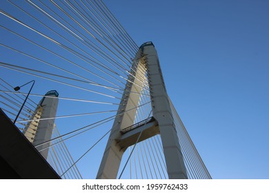Bottom view of the cable-stayed bridge supports and cable stays against the sky 