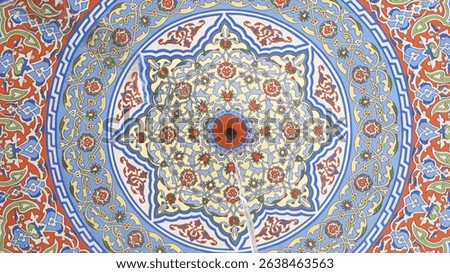Bottom view of the ceiling decorated with colorful Islamic motifs.