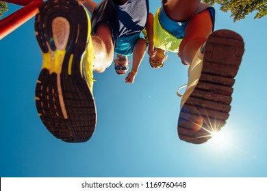 Bottom view cropped image of two people in sneakers. Staying fit urban style.