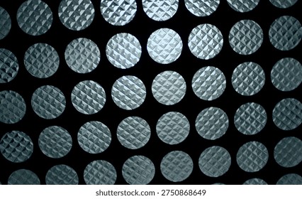 Bottom view of a dimly lit ceiling light with round glass panels
