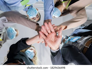 Bottom View Of A Group Of Businessmen And Women Wear A Mask And Take Hand Coordination In The Office. Job Successes And Teamwork Concept. Work Of Diversity Of Culture. Good Environment In Workplace.
