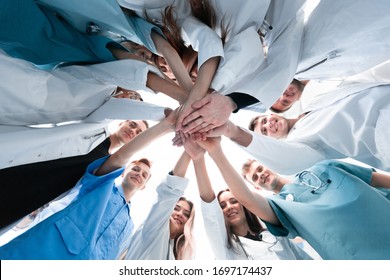 bottom view. a group of medical colleagues putting their hands together. - Powered by Shutterstock