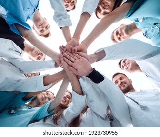 bottom view. a group of medical colleagues putting their hands together.