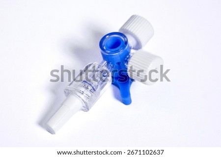 Bottom view of Injection connector object with blue switch valve isolated on white background.