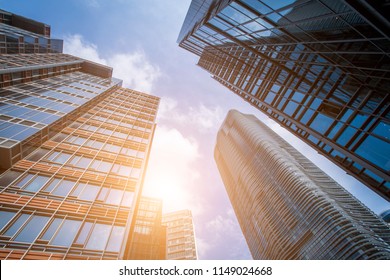 Bottom view of modern skyscrapers in business district against blue sky - Shutterstock ID 1149024668