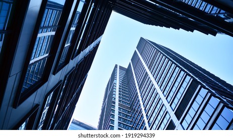 Bottom view of modern skyscrapers in business district against blue sky. Looking up at business buildings in downtown. - Shutterstock ID 1919294339