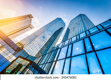 Bottom view of modern skyscrapers in business district at sunset with lens flare filter effect - Shutterstock ID 245476081