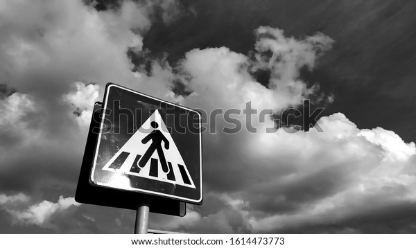 bottom view of pedestrian crossing sign with blue\
sky with clouds. copy\
space