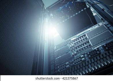 Bottom view of rack server against neon light in data center with dept of field