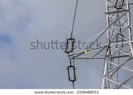 Bottom view of a section of a high-voltage overhead line pole.
