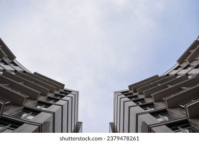 Bottom view of the sky and the sharp corners of high-rise buildings.  Part of modern buildings against the sky