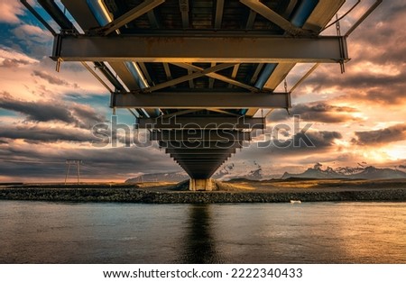 Bottom view of Suspension bridge structure over Jokulsarlon glacier lagoon with sunset sky in summer at Iceland