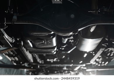 Bottom view of the underbody of a car on a lift.  - Powered by Shutterstock