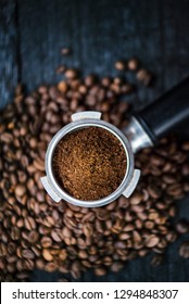 Bottomless Filter With Grind Beans On A Wooden Black Table. Roasted Coffee Beans. Espresso Coffee Extraction. Prepare Of Espresso.