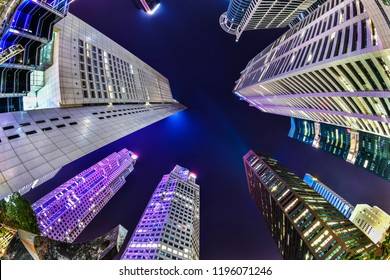 A Bottom-up Night View Of A Group Of Buildings In A Business District In Singapore With Fish Eye Lens