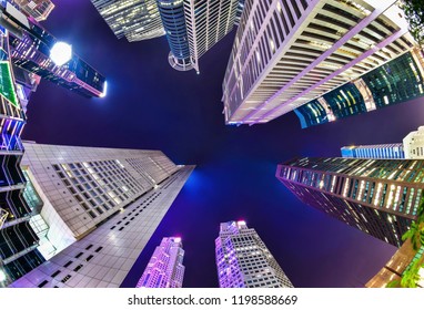 A Bottom-up Night View Of A Group Of Buildings In A Business District In Singapore With Fish Eye Lens