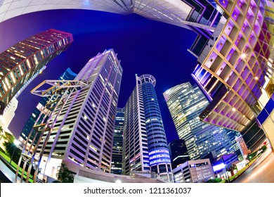 A Bottom-up Night View Of A Group Of Buildings In A Business District In Singapore With Fish Eye Lens