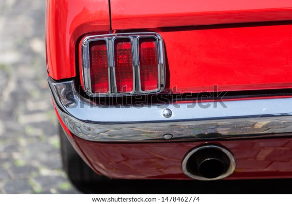 Bottrop,\
Germany - June 07, 2019: tail light of an old Ford Mustang. The\
Ford Mustang series was introduced in 1964 and was the beginning of\
the popular pony car class of American\
cars