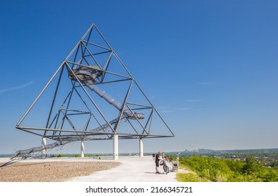 BOTTROP, GERMANY - MAY 09, 2022: Cyclists on top of the hill at the tetrahedron in Bottrop, Germany