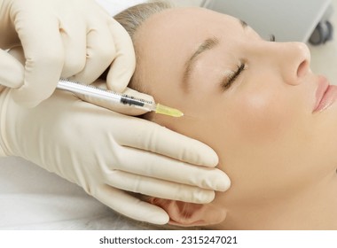 Botulinum toxin injection for facial wrinkles  ,in the therapy of mimic facial lines, non-invasive treatment for mimic facial wrinkles and neck and decollete lines.Cosmetic botulinum toxin injection - Shutterstock ID 2315247021