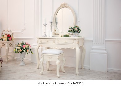 Boudoir table. Details of the interior of the bedroom for girls and make-up, hairstyles with a mirror